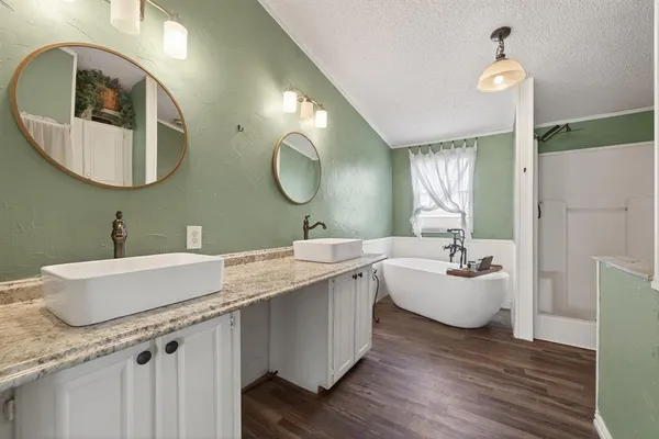 a bathroom with a double vanity sink and a mirror