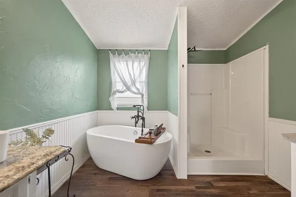 a bathroom with a granite countertop tub sink and shower