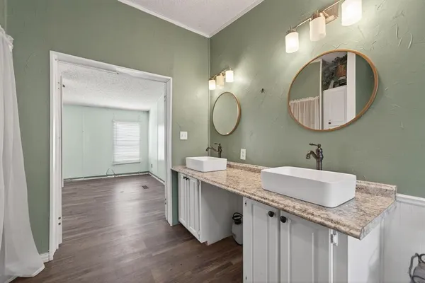 a bathroom with a double vanity sink and a mirror