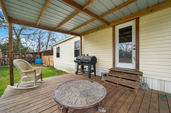 a view of two chairs in the patio