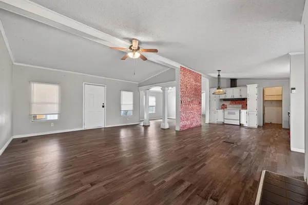 a view of empty room with wooden floor and fireplace