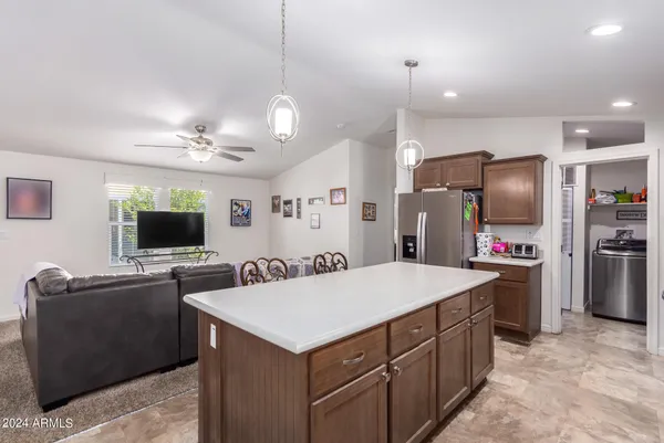 a kitchen with kitchen island and stainless steel appliances