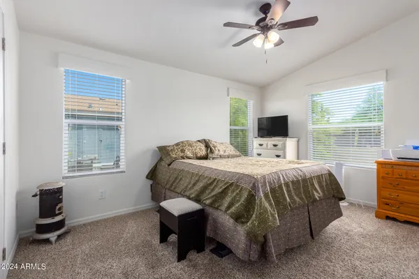 a bed sitting in a bedroom next to a window