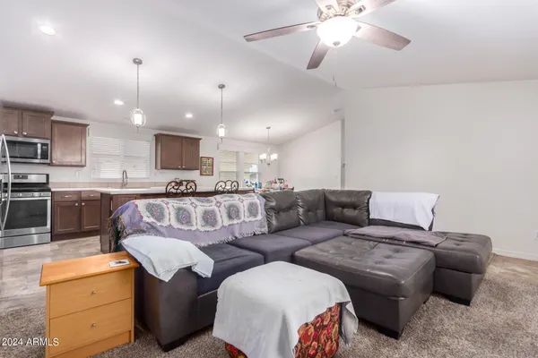 a living room with furniture and kitchen view