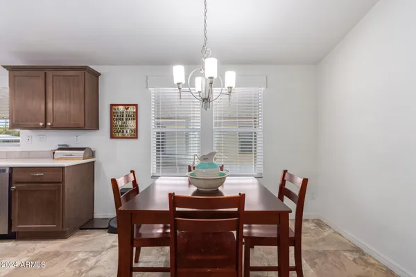 a dining room with furniture and window