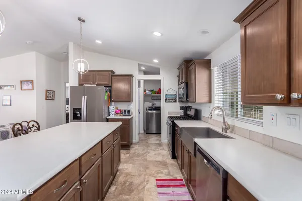 a kitchen with a sink stove and refrigerator