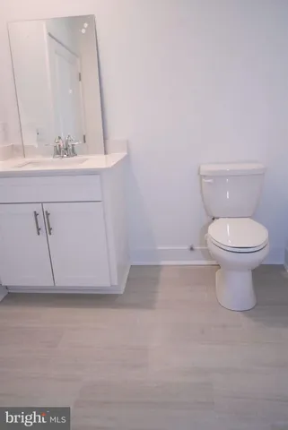 a bathroom with a sink a toilet and mirror