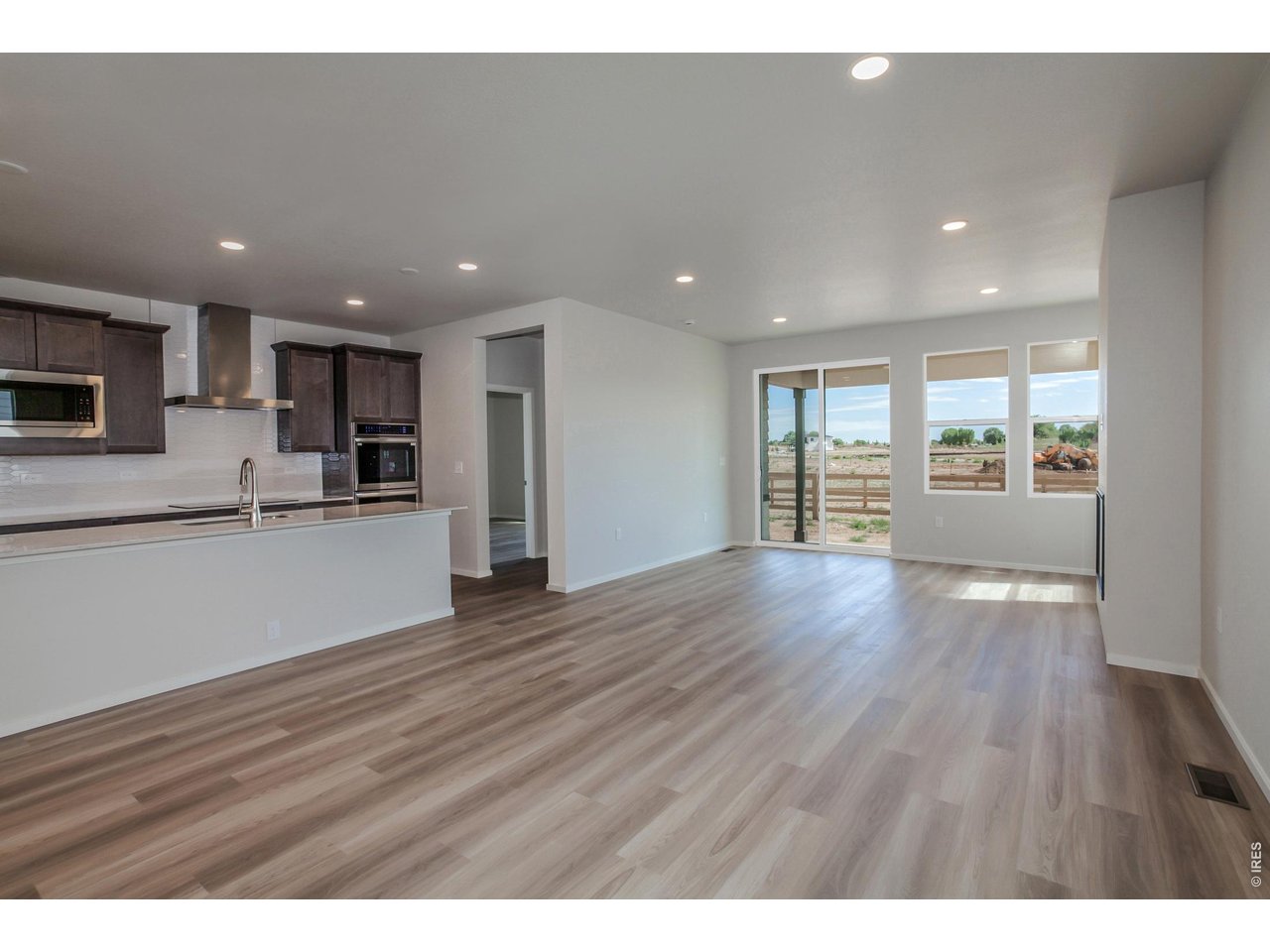 792 Chatter Road Windsor, CO 80550 - Photo 11 of 49 a view of kitchen with wooden floor and electronic appliances
