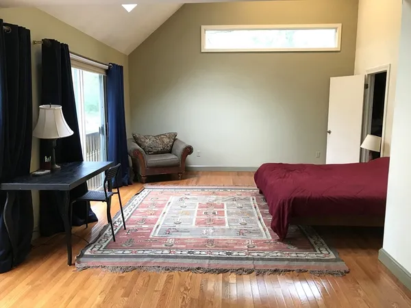 a bed sitting in a bedroom next to a window