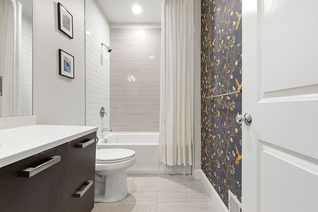 299 Sumner Street, Unit 1 Boston, MA 02128 - Photo 18 of 23 a bathroom with a sink toilet and shower