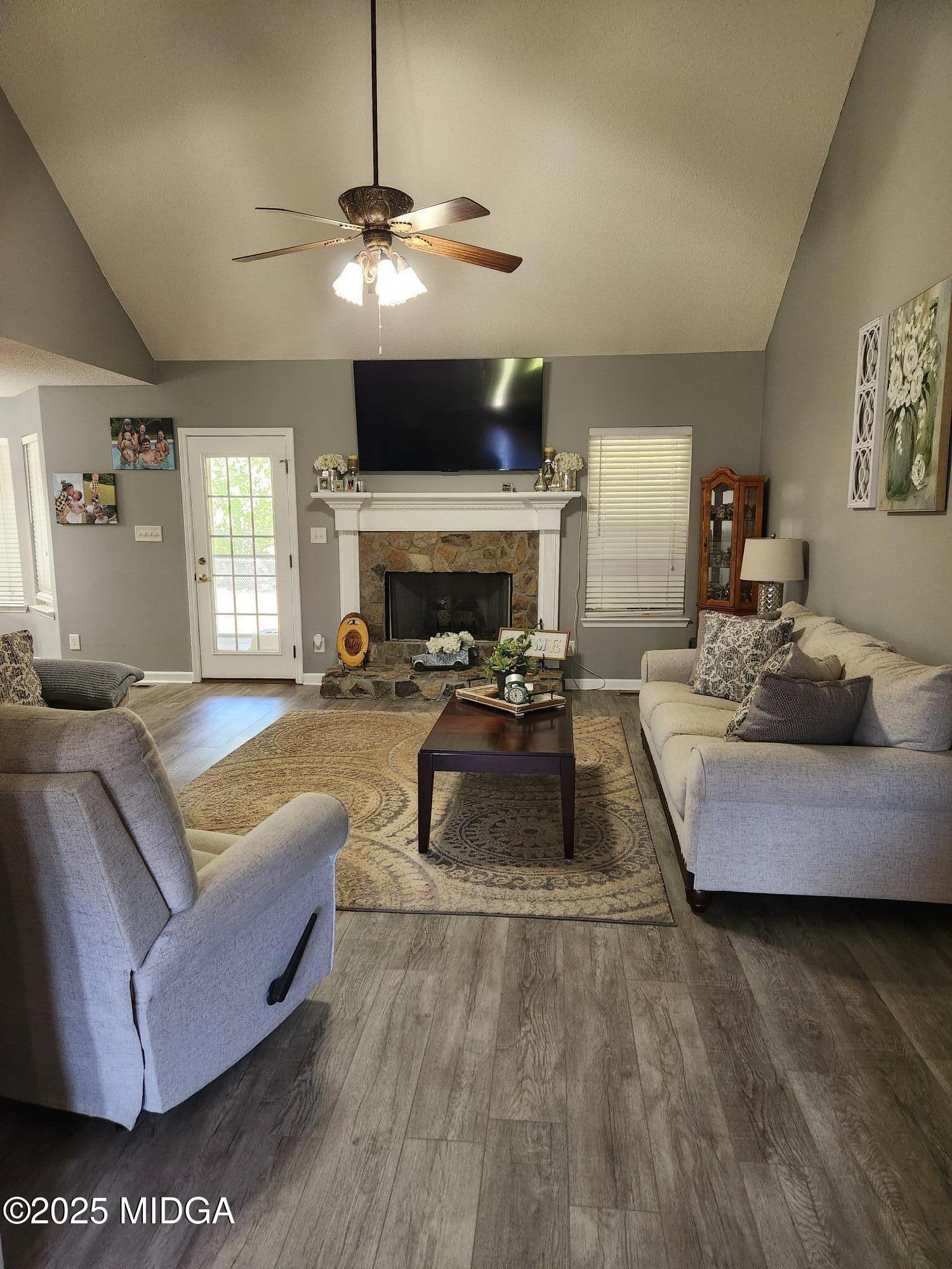 254 Crestview Lane Gray, GA 31032 - Photo 2 of 15 a living room with furniture a fireplace and a flat screen tv