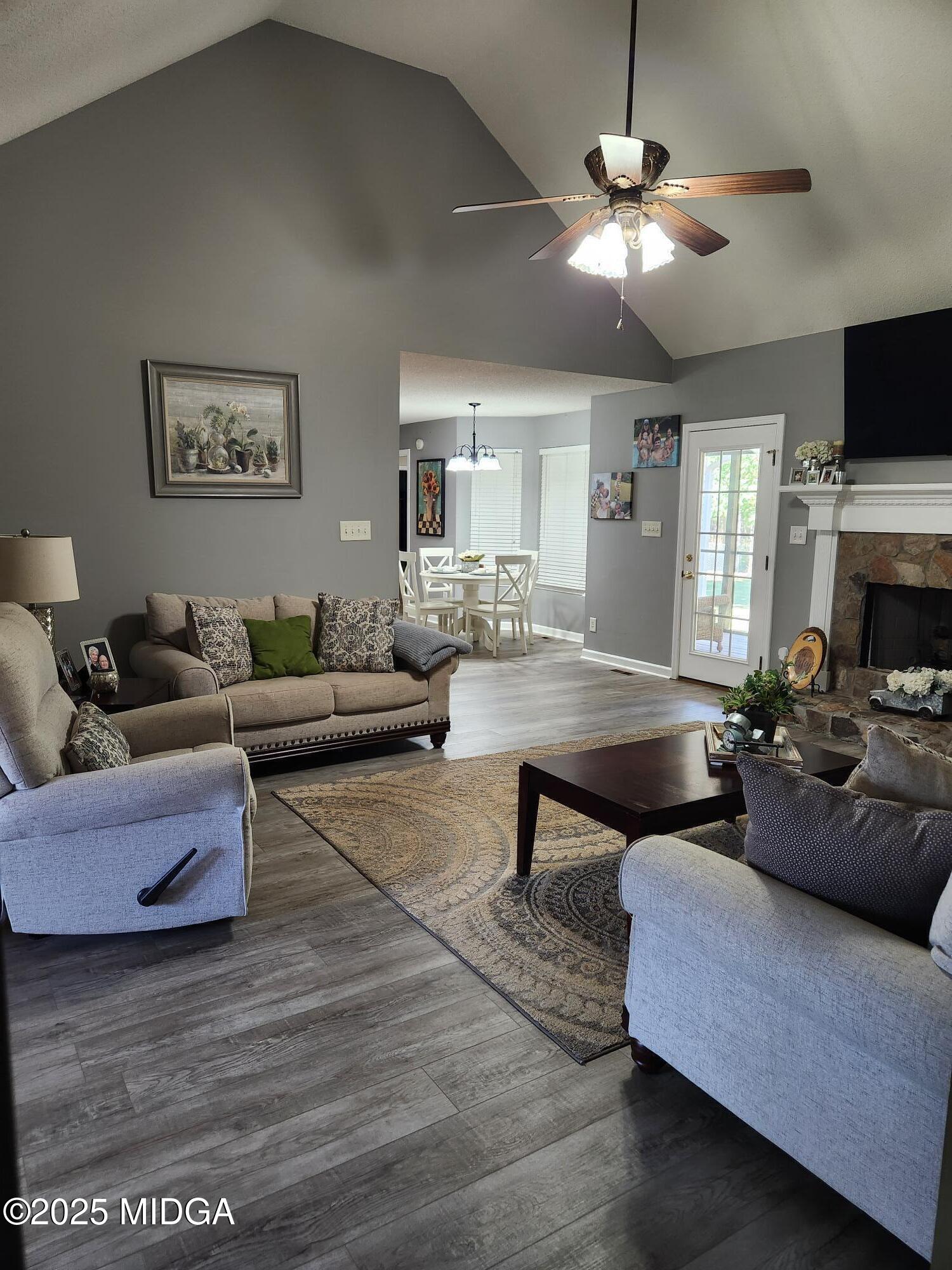254 Crestview Lane Gray, GA 31032 - Photo 3 of 15 a living room with furniture a chandelier and a flat screen tv