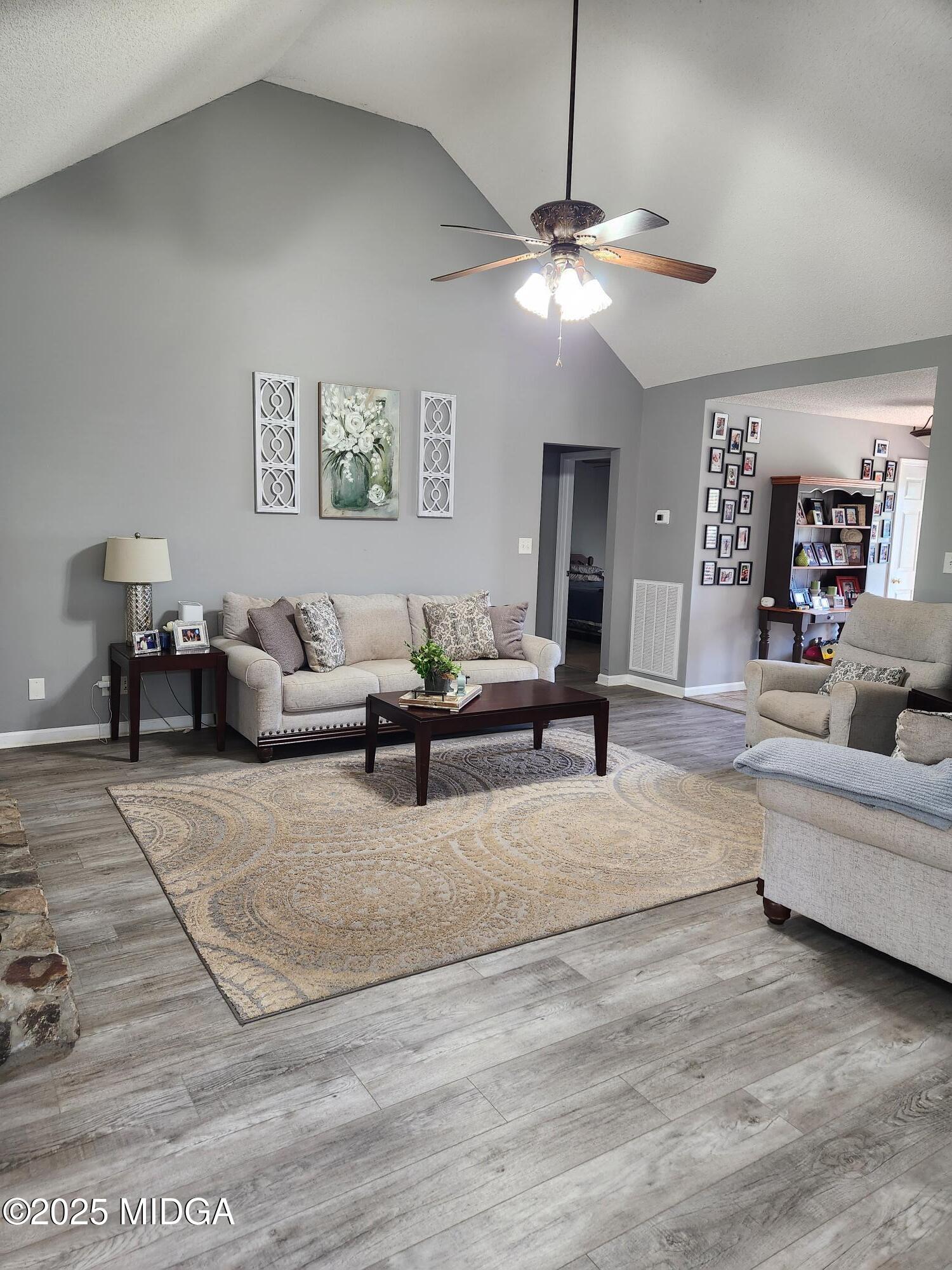 254 Crestview Lane Gray, GA 31032 - Photo 4 of 15 a living room with furniture and a chandelier