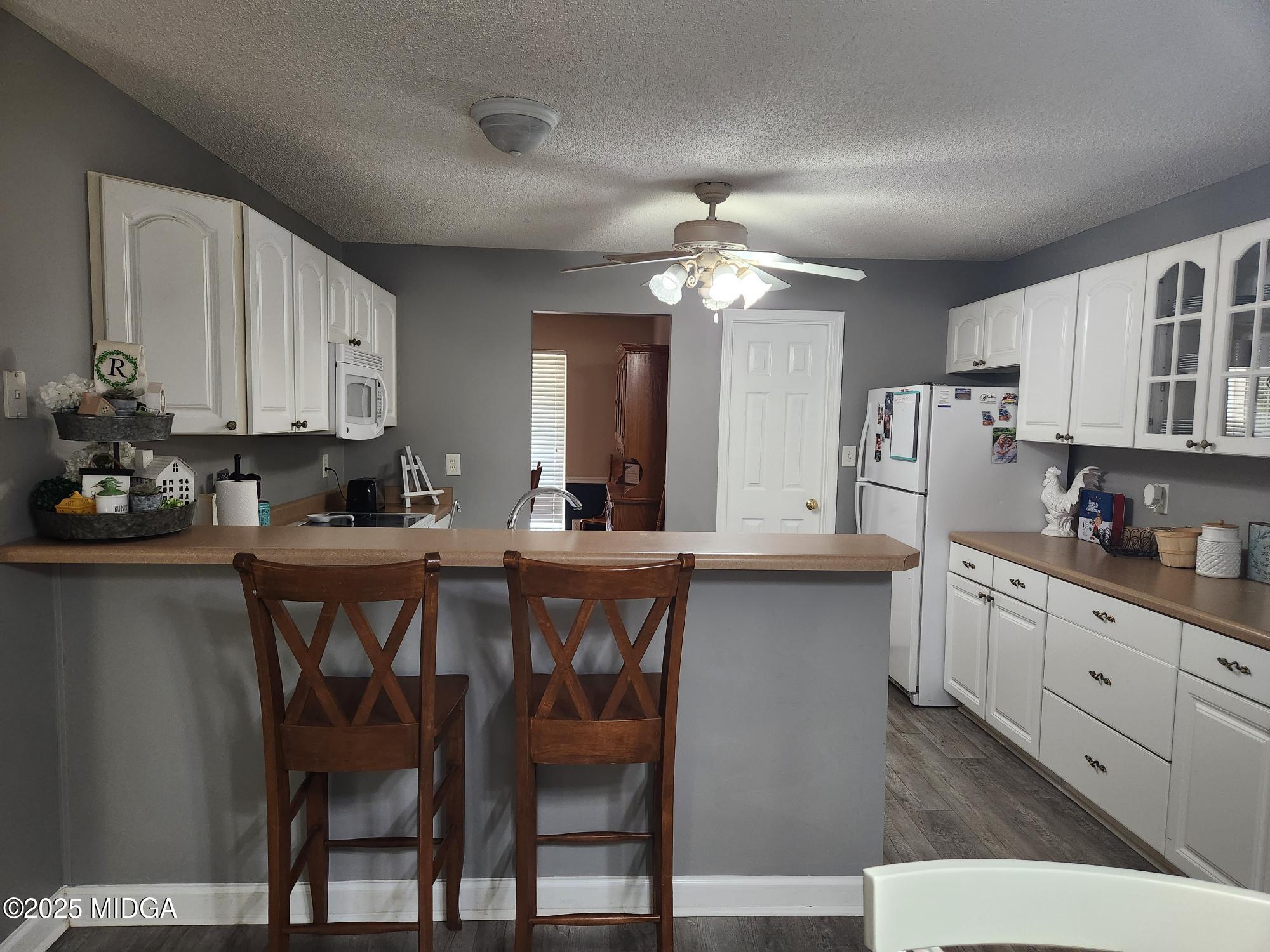 254 Crestview Lane Gray, GA 31032 - Photo 5 of 15 a kitchen with stainless steel appliances a table chairs refrigerator and sink