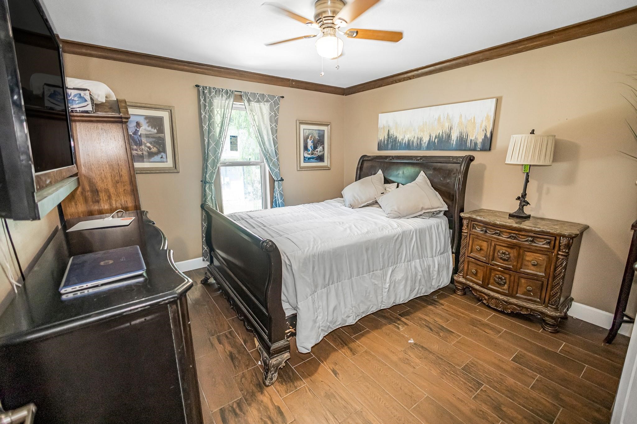 25436 Northampton New Caney, TX 77357 - Photo 12 of 26 a bedroom with a bed and wooden floor