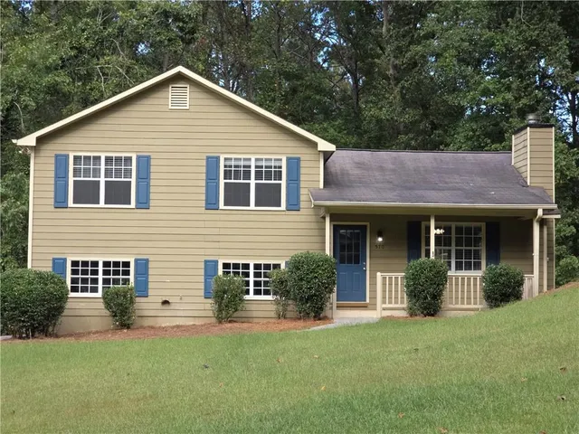 a view of a house with a yard and plants