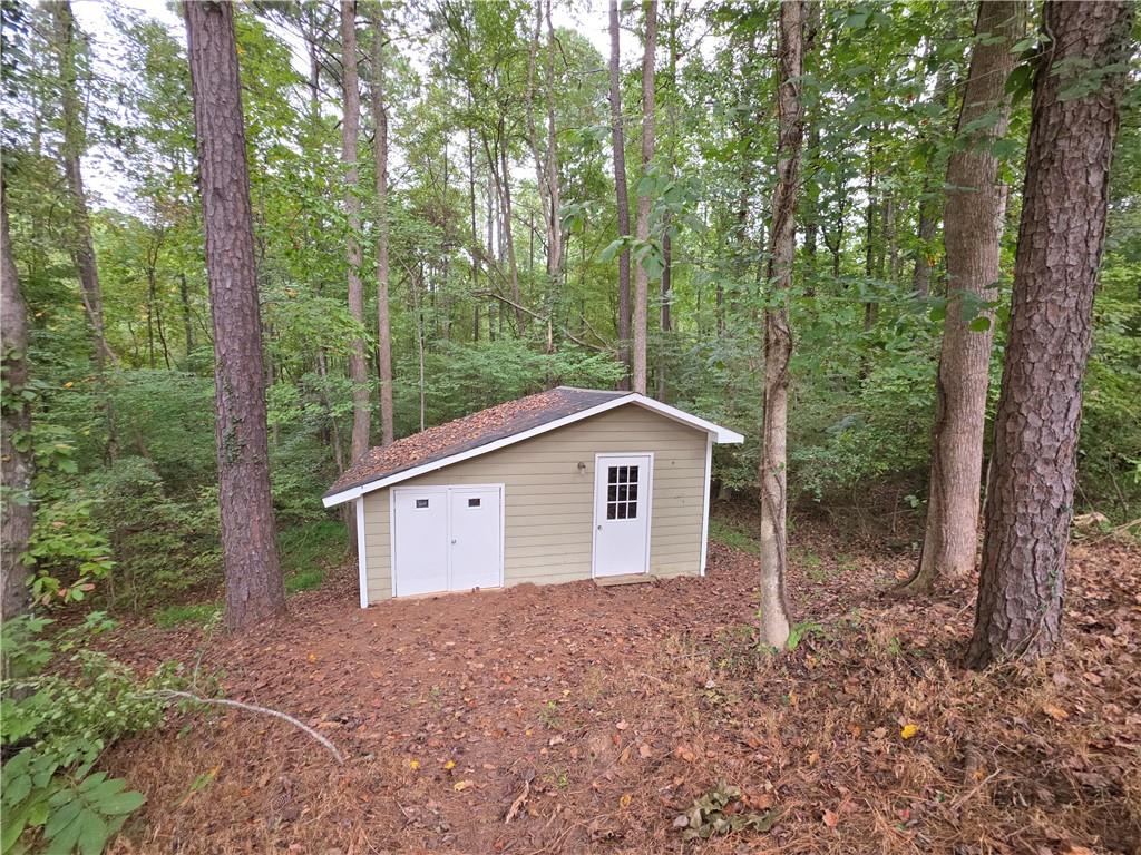 570 Remington Lane Acworth, GA 30101 - Photo 19 of 20 a view of a house with a yard and large trees