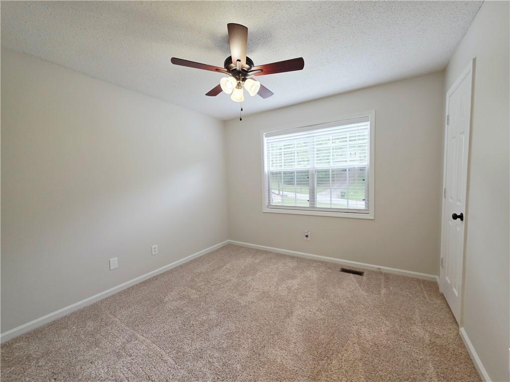 570 Remington Lane Acworth, GA 30101 - Photo 6 of 20 an empty room with a window and a fan