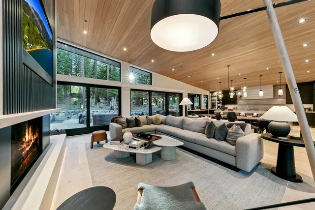 a living room with furniture fireplace and a large window