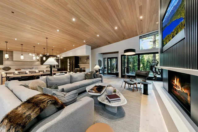 a living room with furniture fireplace and a large window