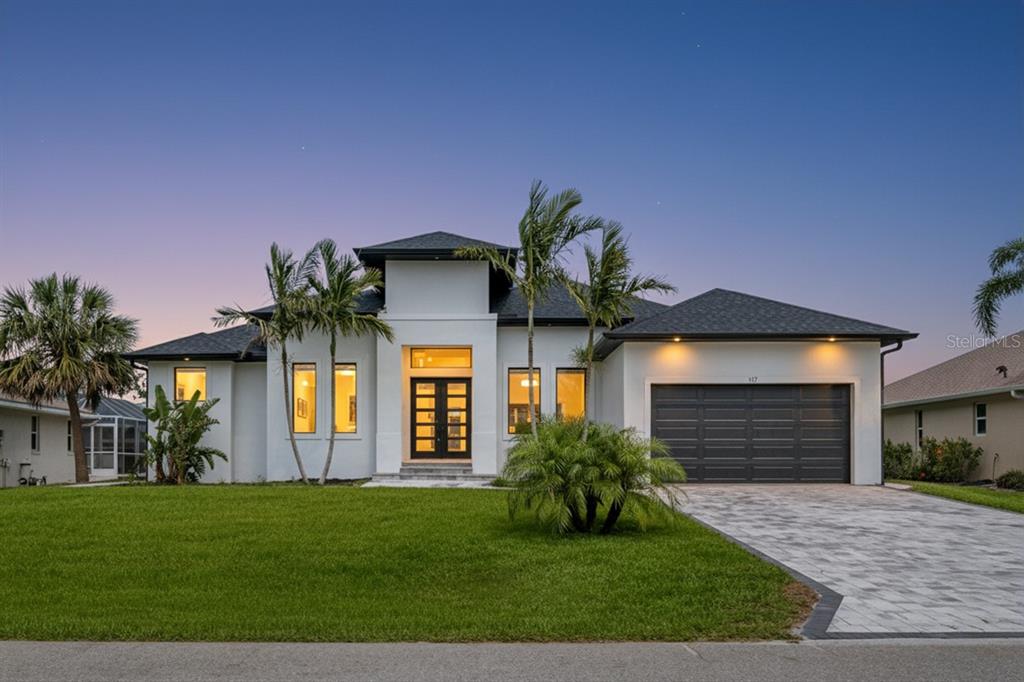 117 Marker Road Rotonda West, FL 33947 - Photo 1 of 1 a front view of a house with a yard and garage