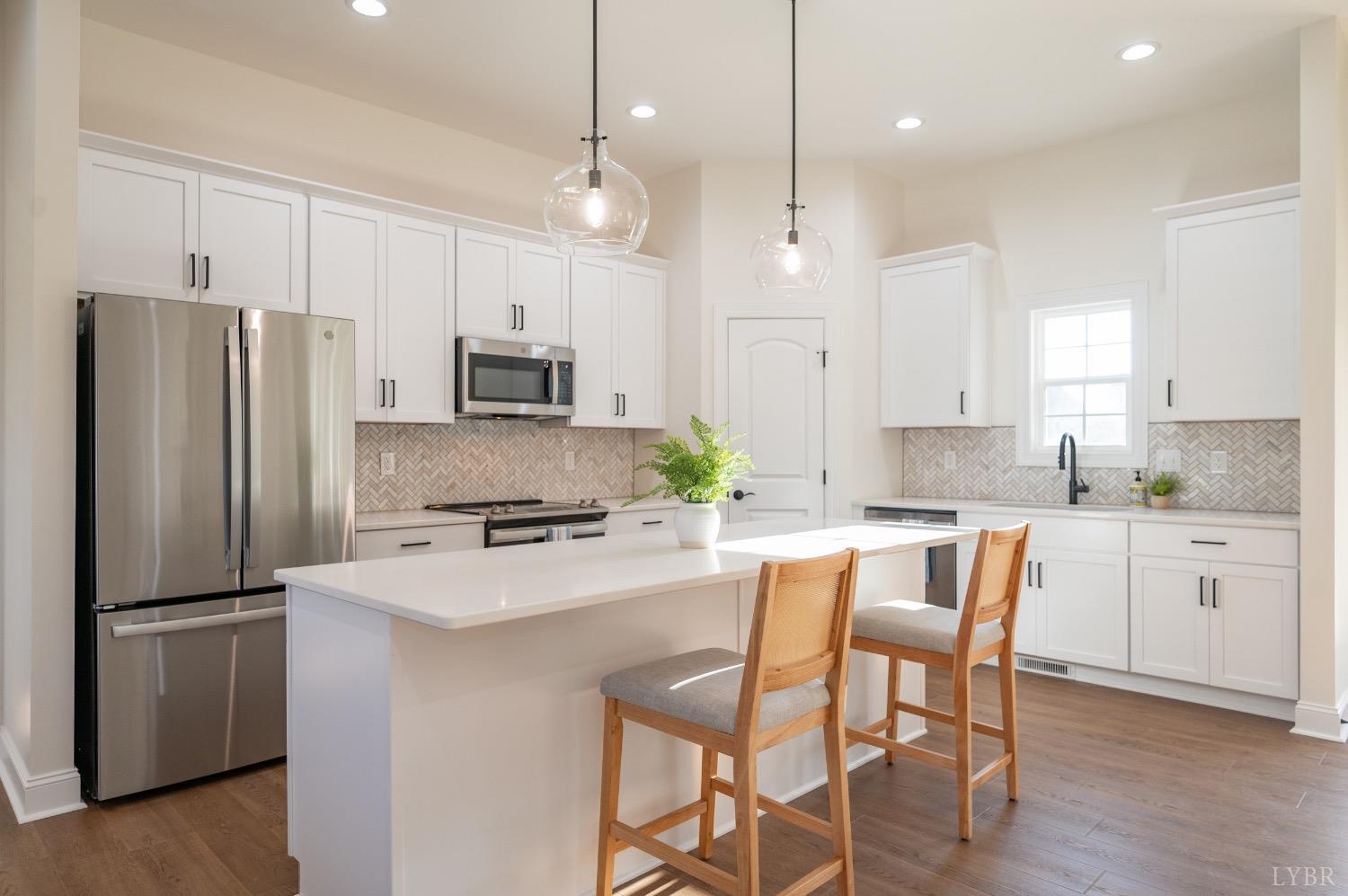 2947 Everett Road Forest, VA 24551 - Photo 3 of 49 a kitchen with white cabinets and stainless steel appliances