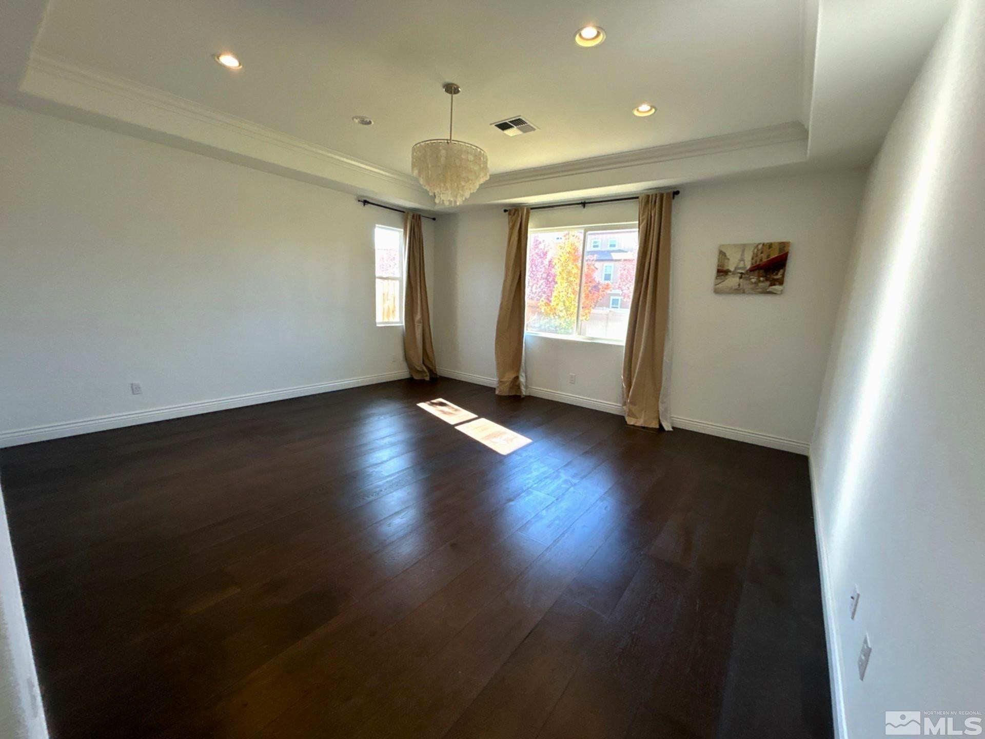 2070 Blue Boy Lane Reno, NV 89521 - Photo 16 of 31 an empty room with wooden floor and windows