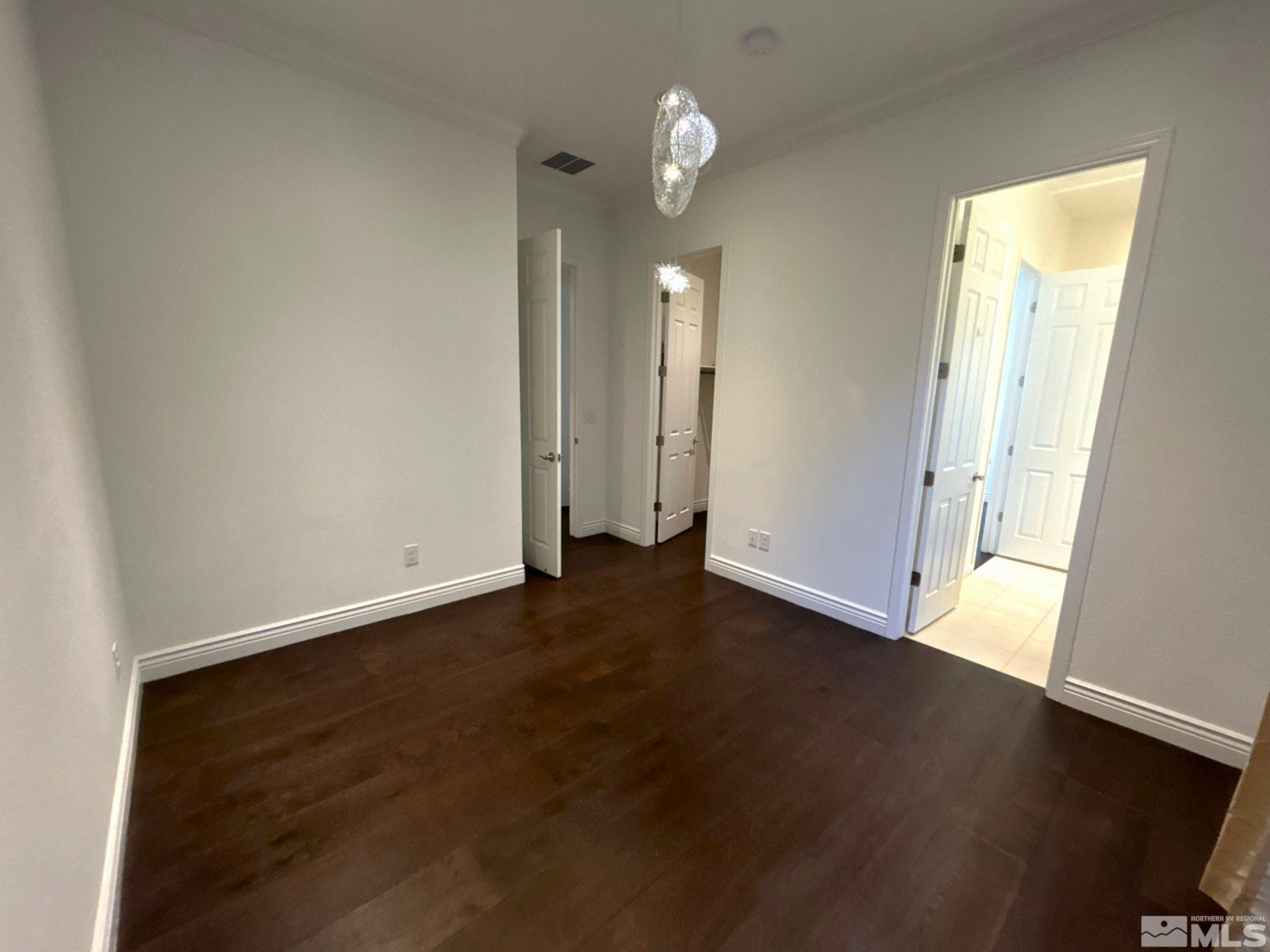 2070 Blue Boy Lane Reno, NV 89521 - Photo 25 of 31 an empty room with wooden floor and windows