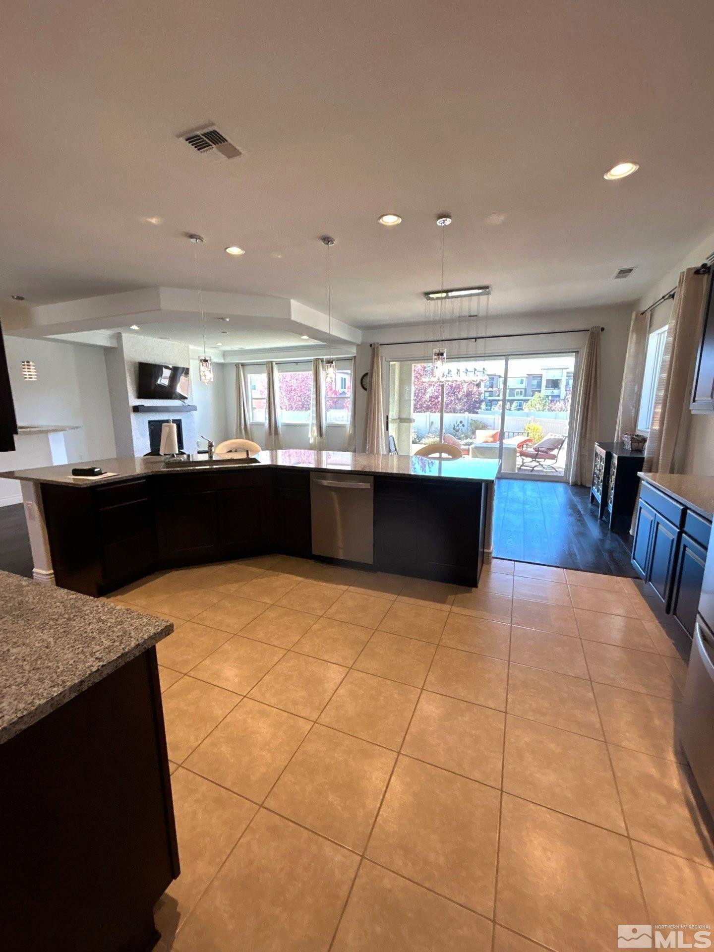2070 Blue Boy Lane Reno, NV 89521 - Photo 26 of 31 a large kitchen with kitchen island a counter top space a sink a window and stainless steel appliances