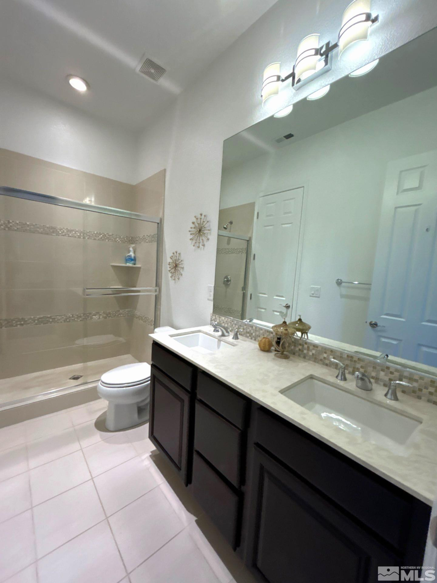 2070 Blue Boy Lane Reno, NV 89521 - Photo 27 of 31 a bathroom with a granite countertop sink a toilet and shower