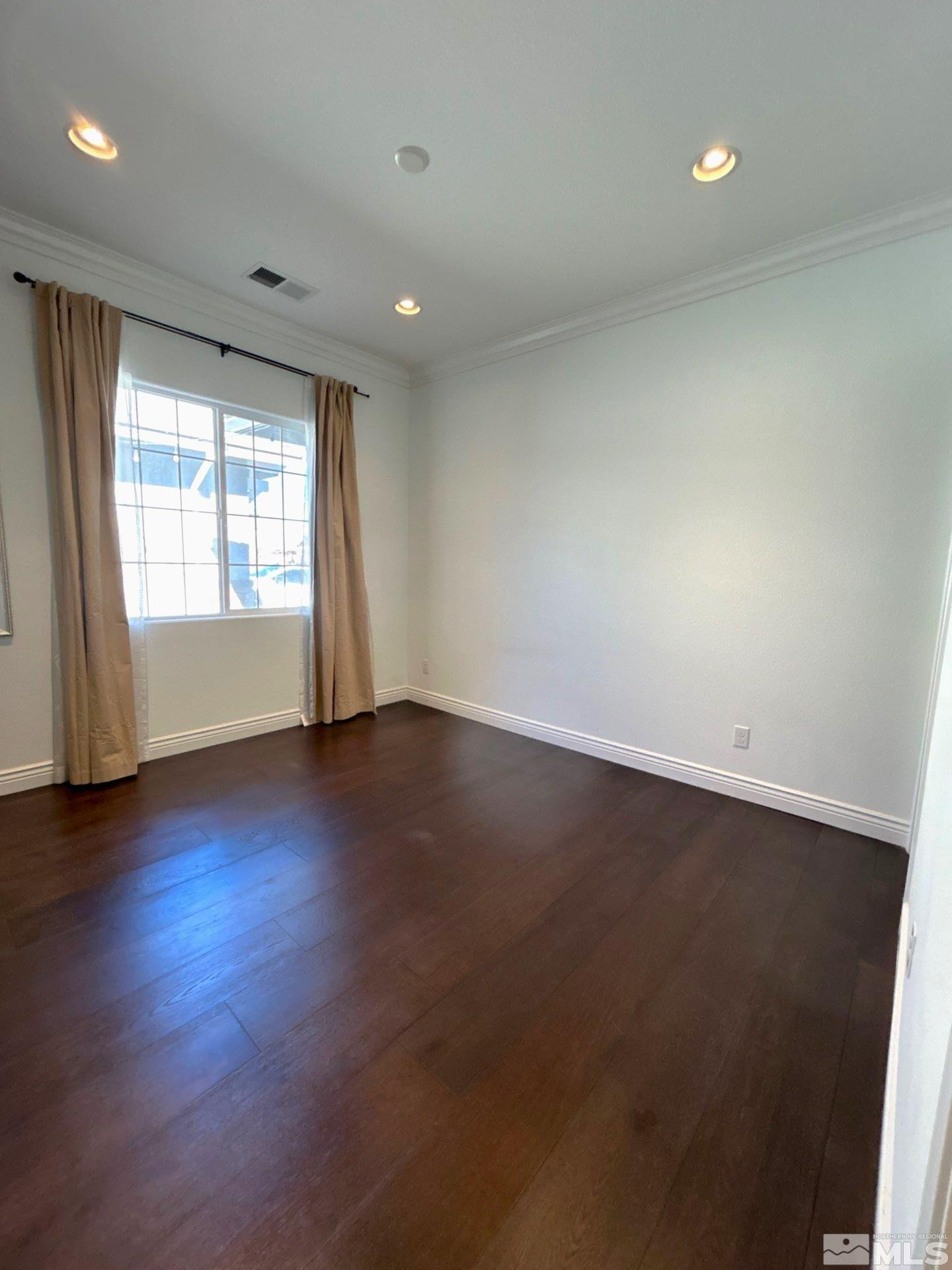 2070 Blue Boy Lane Reno, NV 89521 - Photo 28 of 31 an empty room with wooden floor and windows