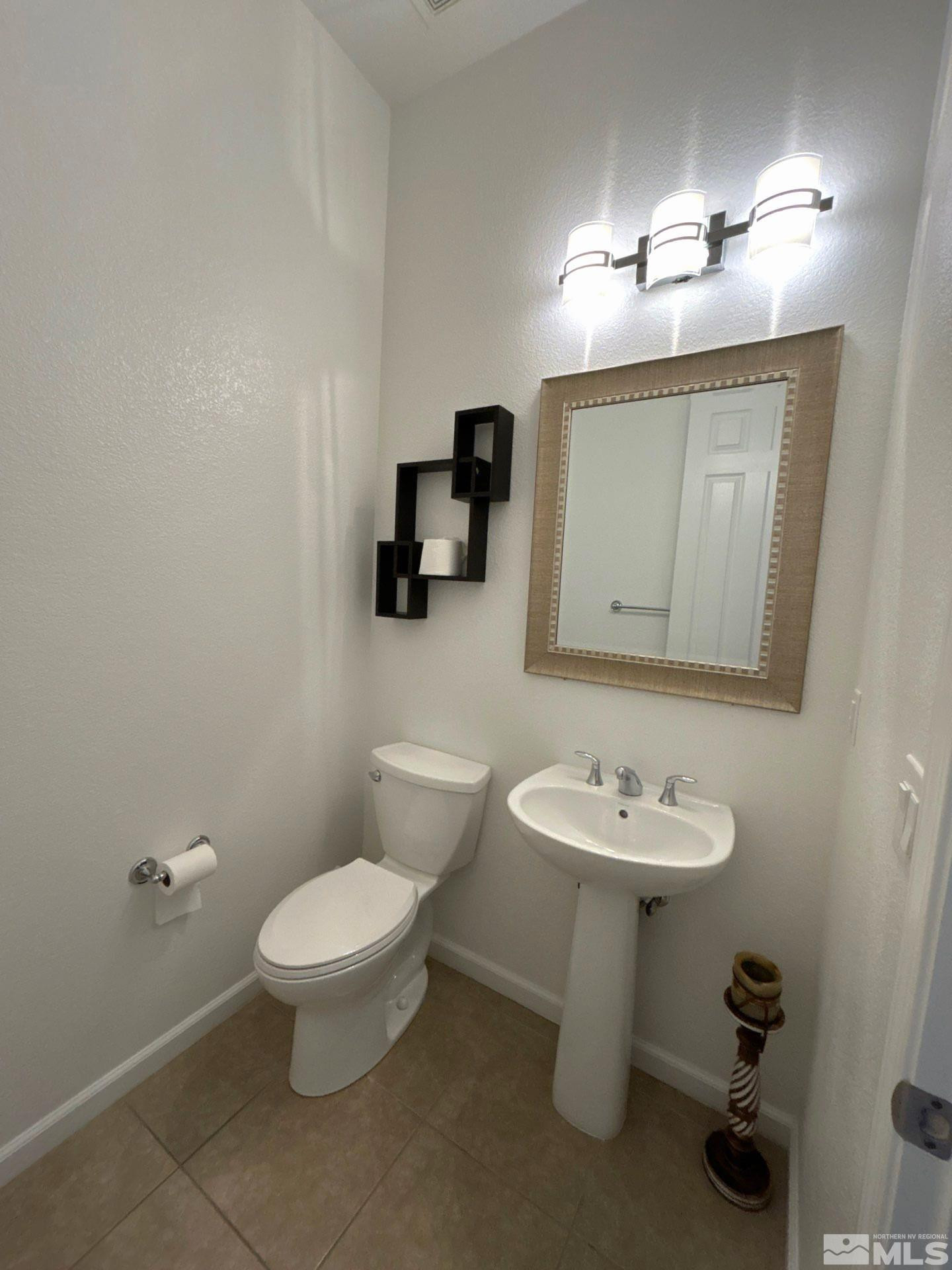 2070 Blue Boy Lane Reno, NV 89521 - Photo 7 of 31 a bathroom with a toilet sink and mirror