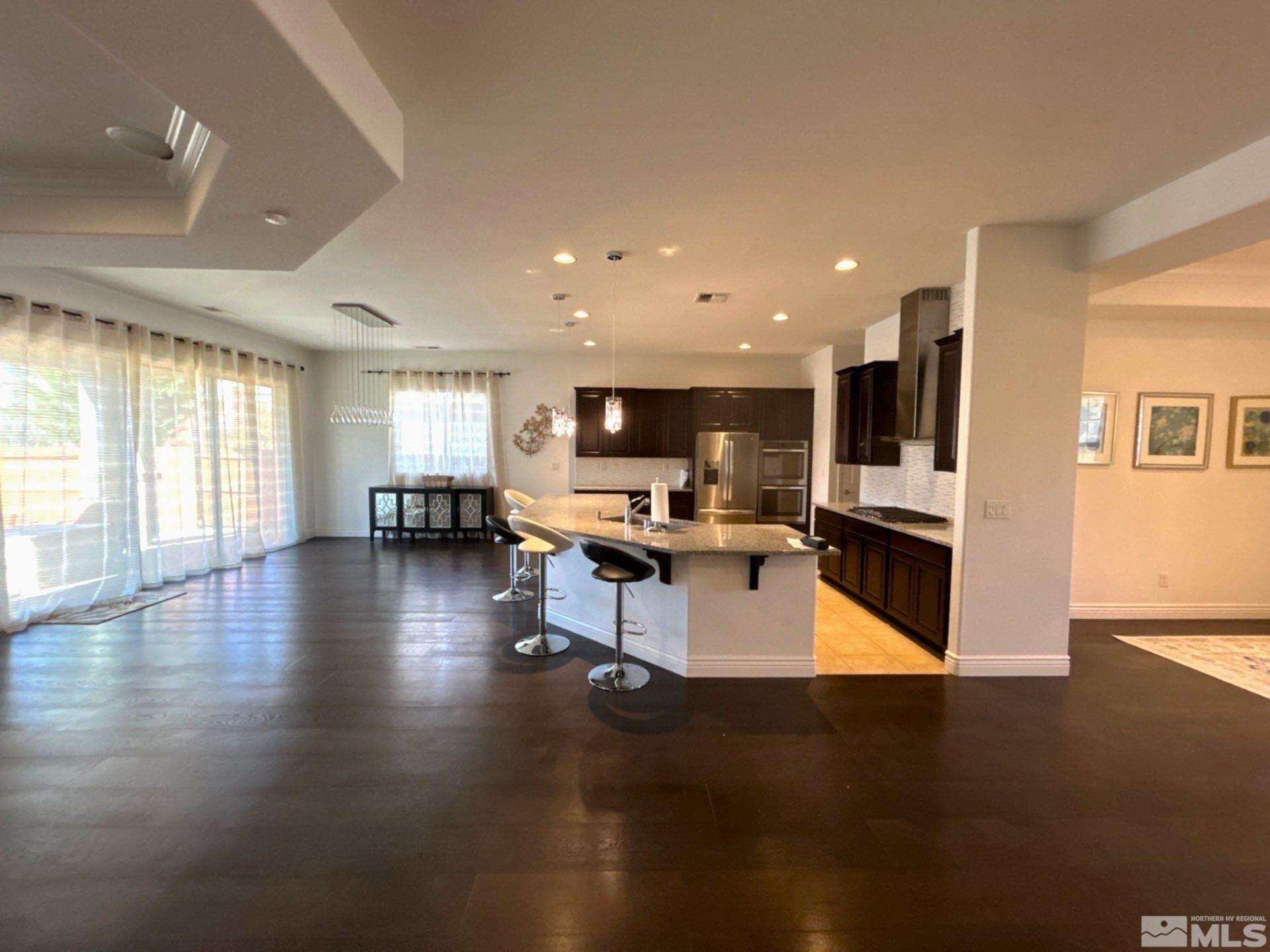 2070 Blue Boy Lane Reno, NV 89521 - Photo 9 of 31 a kitchen with a table chairs refrigerator and a stove