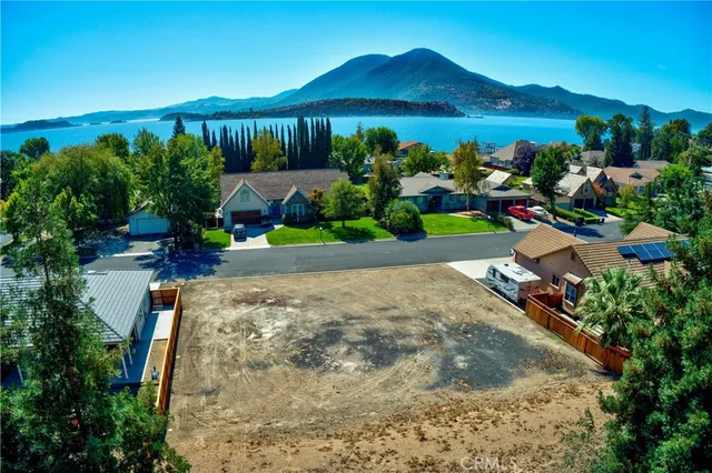 a view of a house with a yard and potted plants
