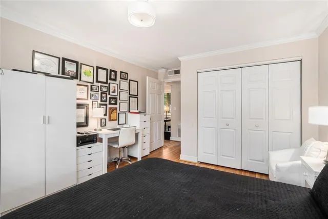 a view of a kitchen with fridge and wooden floor