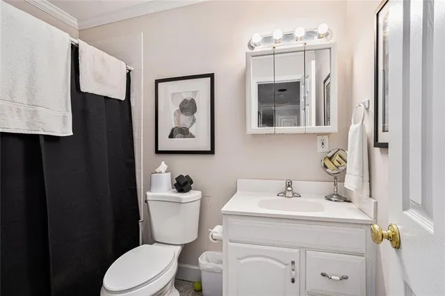 a bathroom with a sink toilet and mirror