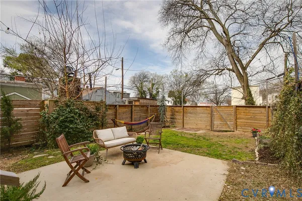 a view of a chairs and table in backyard