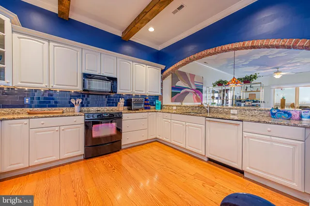 a kitchen with stainless steel appliances granite countertop a sink and cabinets