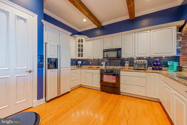 a kitchen with stainless steel appliances granite countertop a refrigerator sink and cabinets