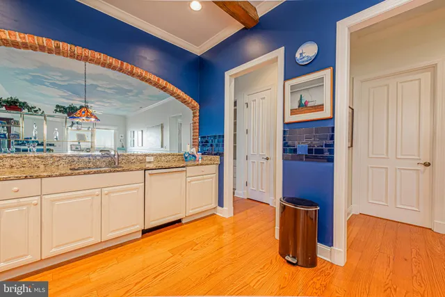 a spacious bathroom with a granite countertop sink and a mirror