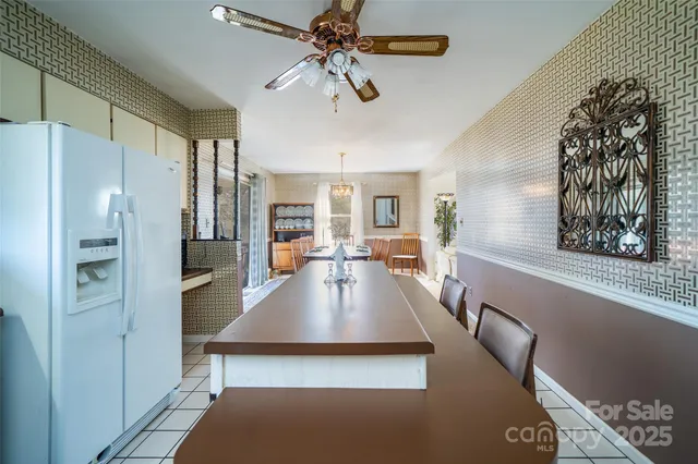 a kitchen with stainless steel appliances granite countertop a refrigerator a stove and a sink