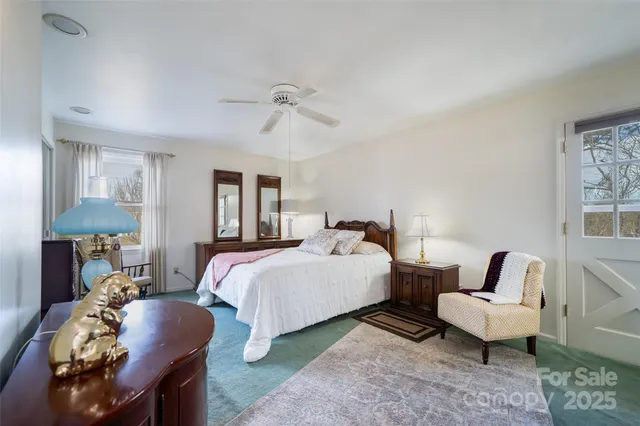 a bed room with bed and a chair