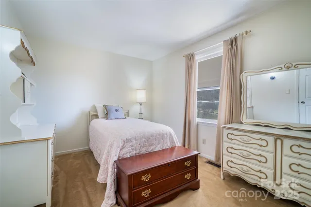 a bedroom with a bed and a mirror