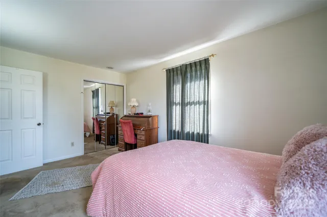 a bed room with a bed and a view of bedroom