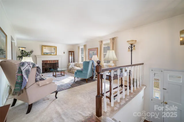 a living room with furniture a fireplace and a wooden floor