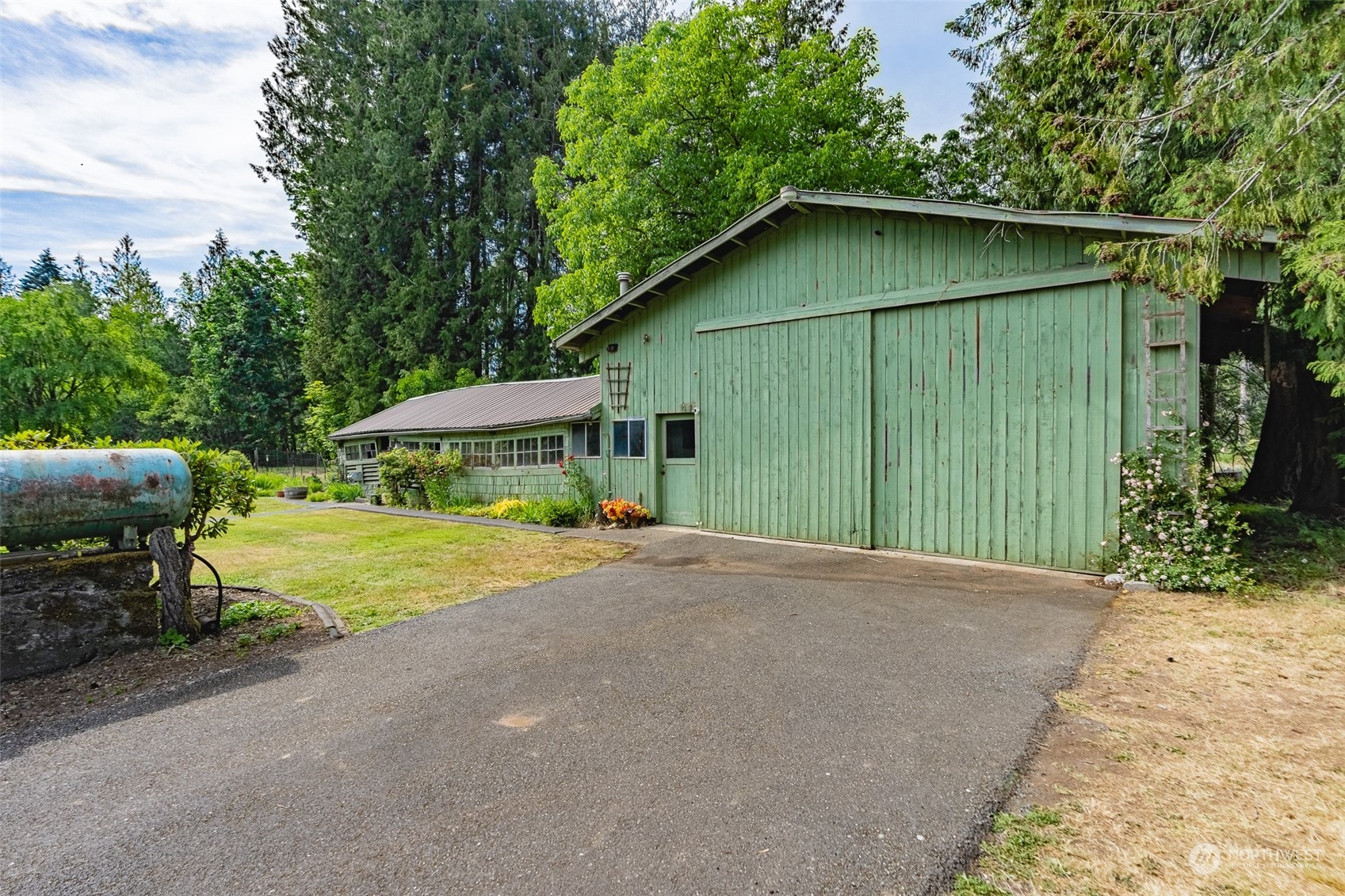 3326 Cedarville Road Bellingham, WA 98226 - Photo 18 of 40 a backyard of a house with barbeque oven table and chairs