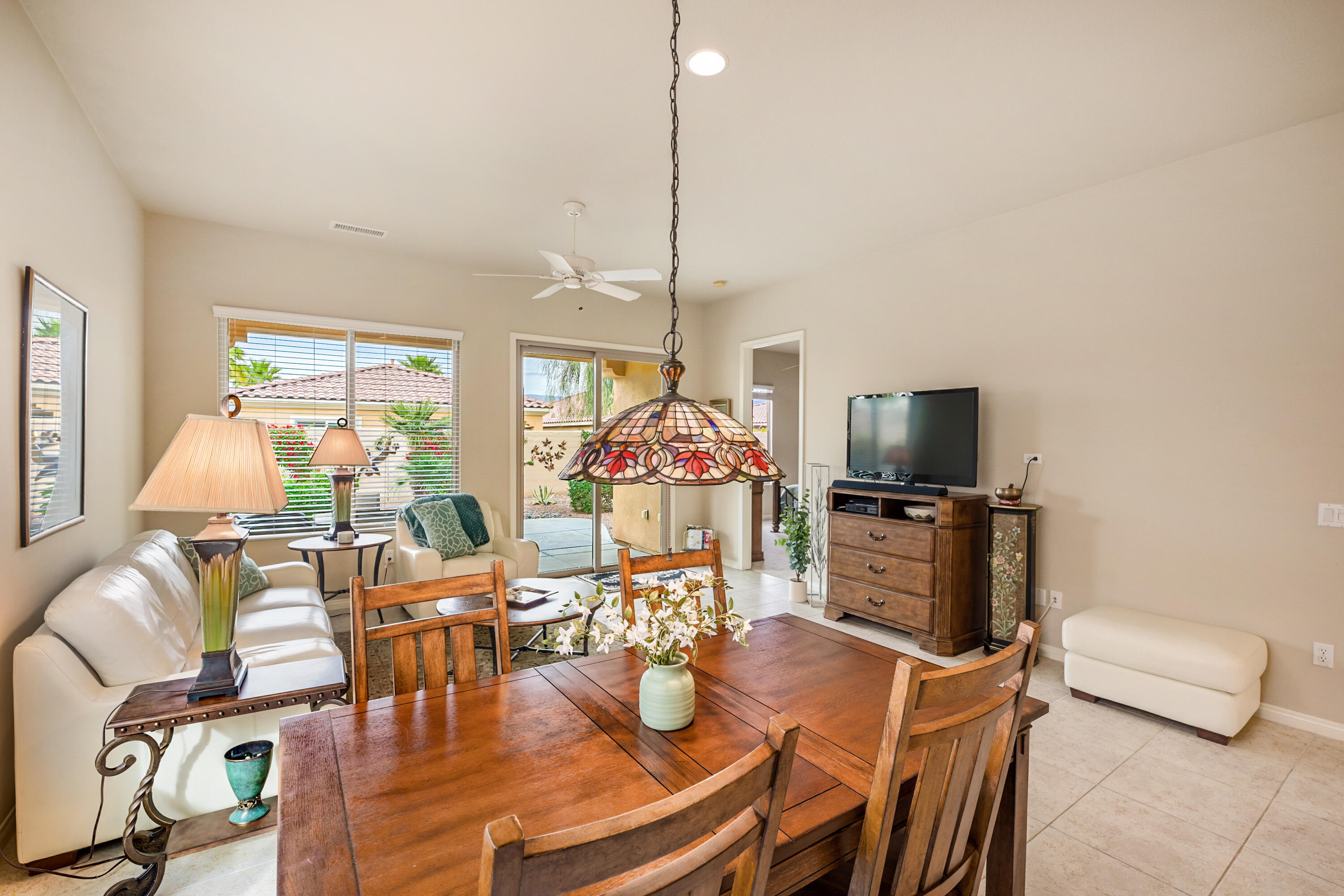 81674 Avenida Celaya Indio, CA 92203 - Photo 13 of 43 a living room with furniture a flat screen tv and a large window