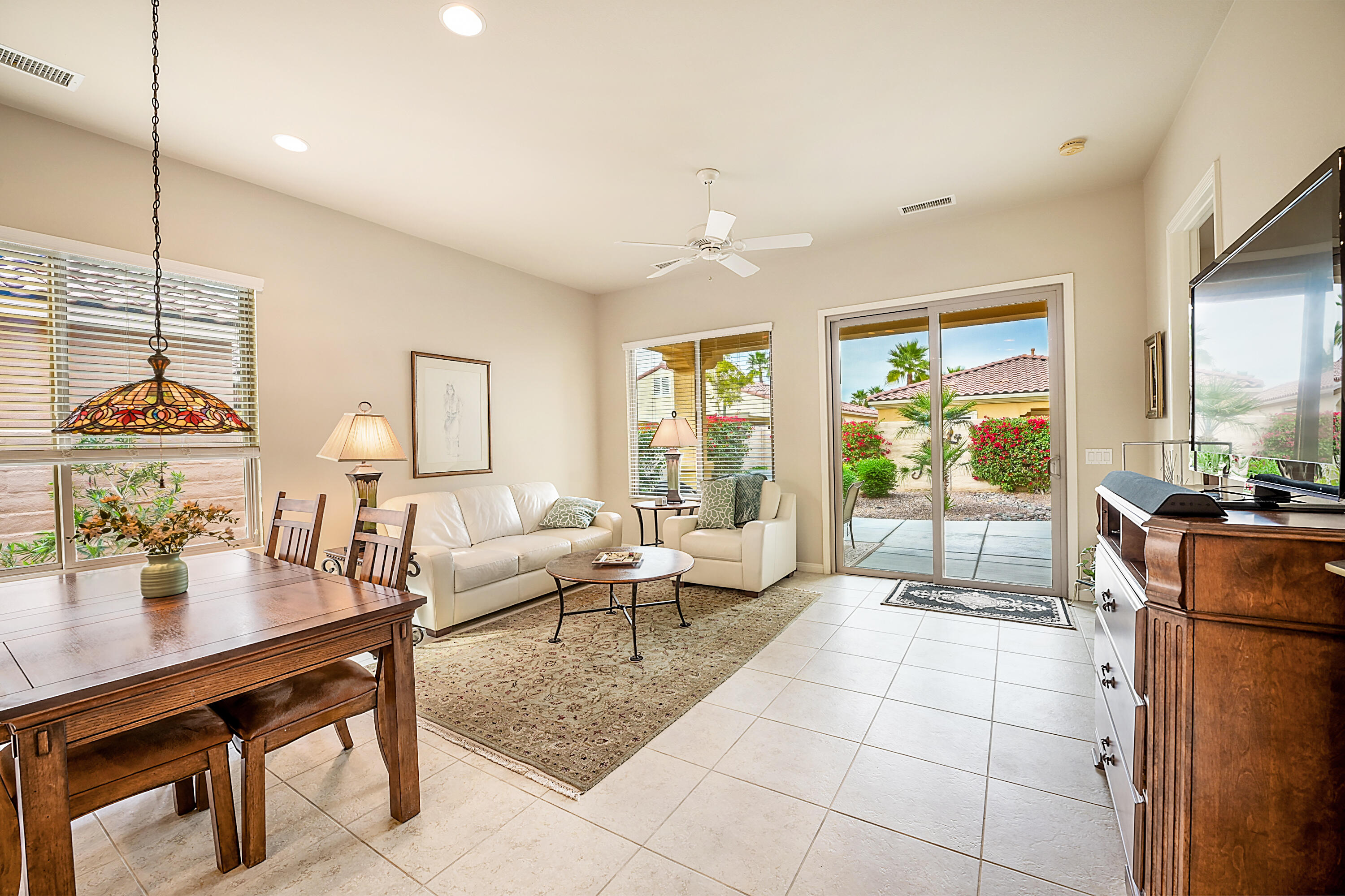 81674 Avenida Celaya Indio, CA 92203 - Photo 4 of 43 a living room with furniture a large window and kitchen view