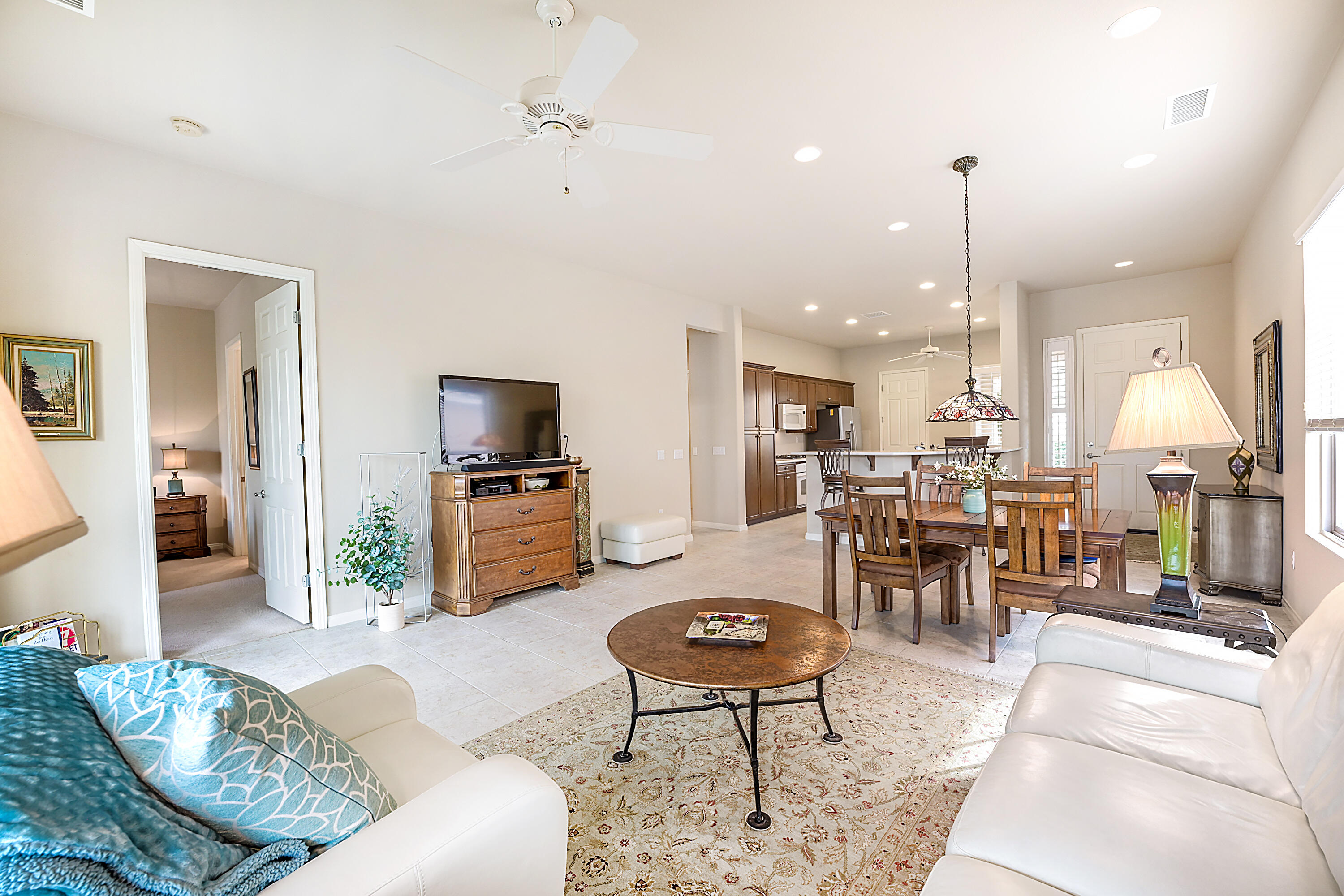 81674 Avenida Celaya Indio, CA 92203 - Photo 5 of 43 a living room with furniture kitchen view and a chandelier