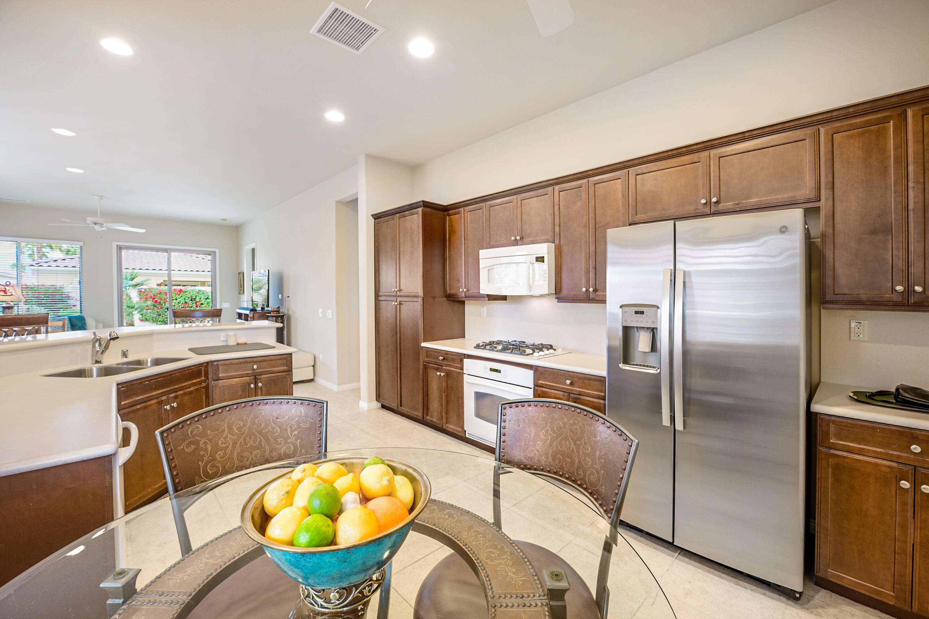 81674 Avenida Celaya Indio, CA 92203 - Photo 9 of 43 a kitchen with stainless steel appliances granite countertop a refrigerator a stove and a sink